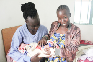 Jackline-Midwife (left), Mother to newborn baby Jesca at HHHF_936x624 (1).jpg